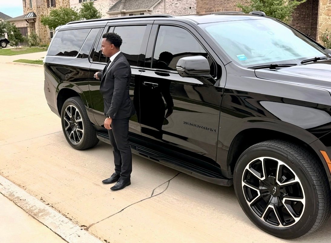 NoirRide chauffeur beside Suburban for hourly service